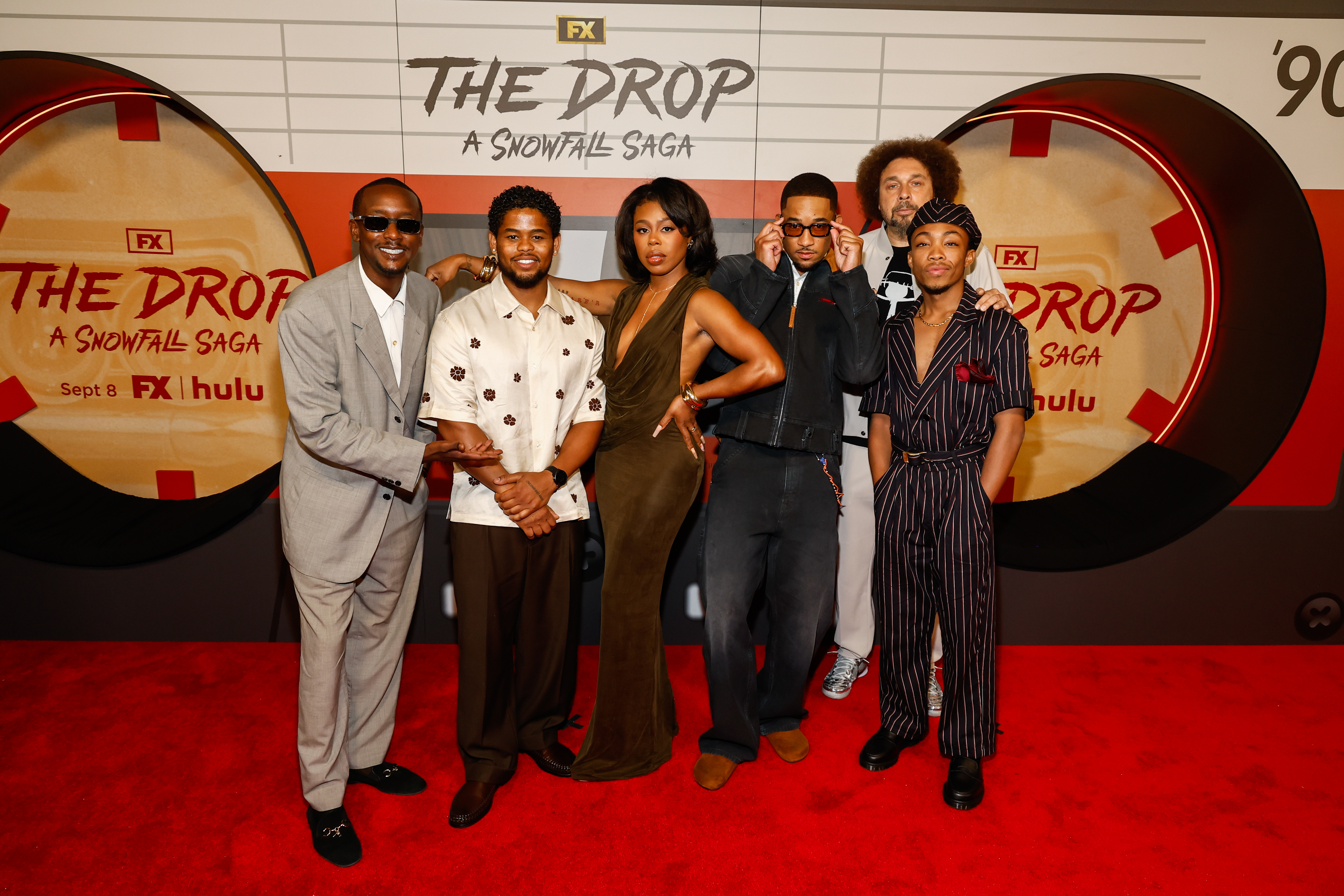 (L-R) Simmie ‘Buddy’ Sims III, Isaiah John, Gail Bean, Peyton Alex Smith, Malcolm Spellman, and Asante Blackk attend FX’s “The Drop: A Snowfall Saga” red carpet launch event at the National Museum of African American History and Culture on September 1, 2026 in Washington, D.C.