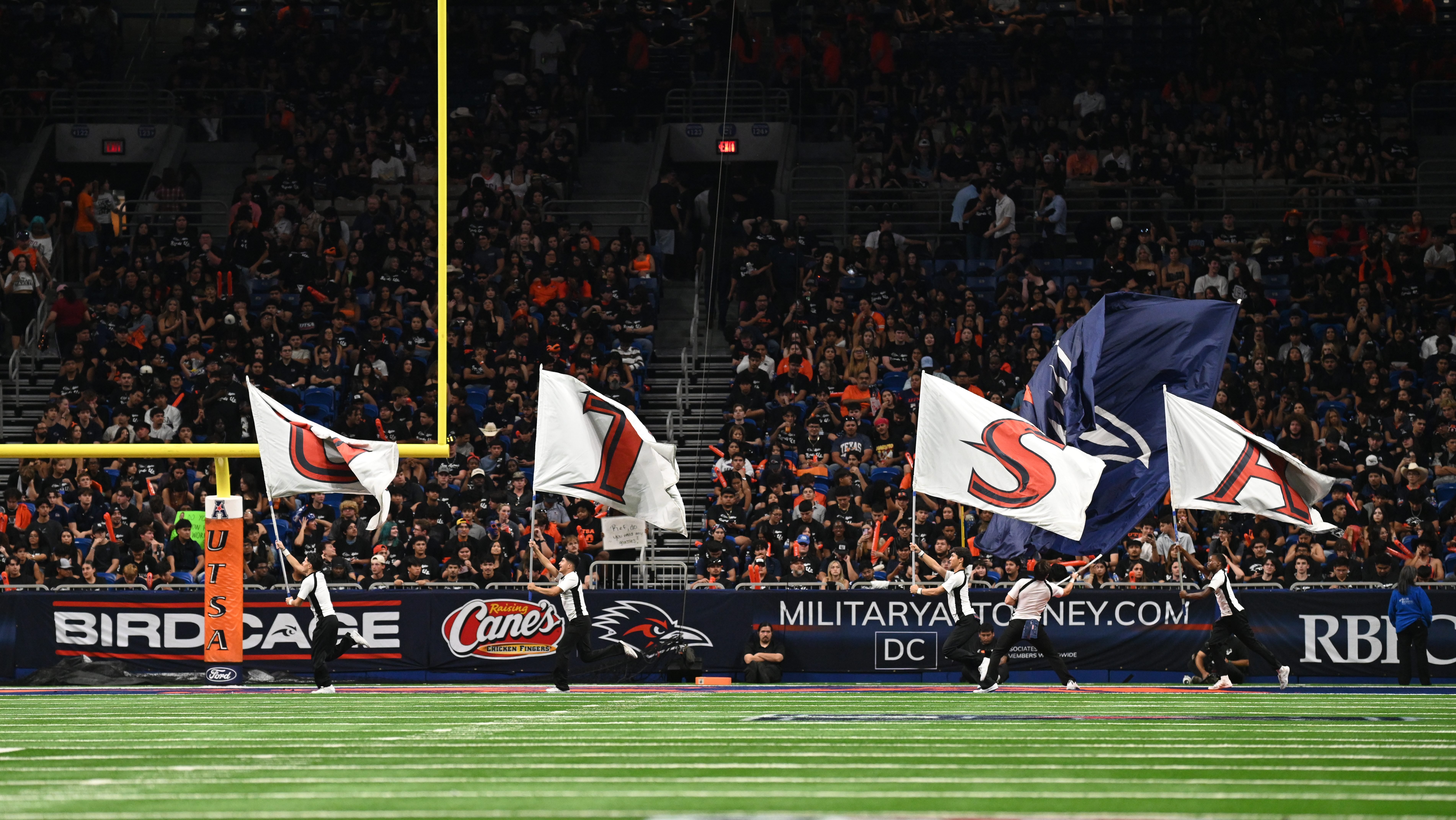 Service member dies after falling during pregame demonstration at college football game